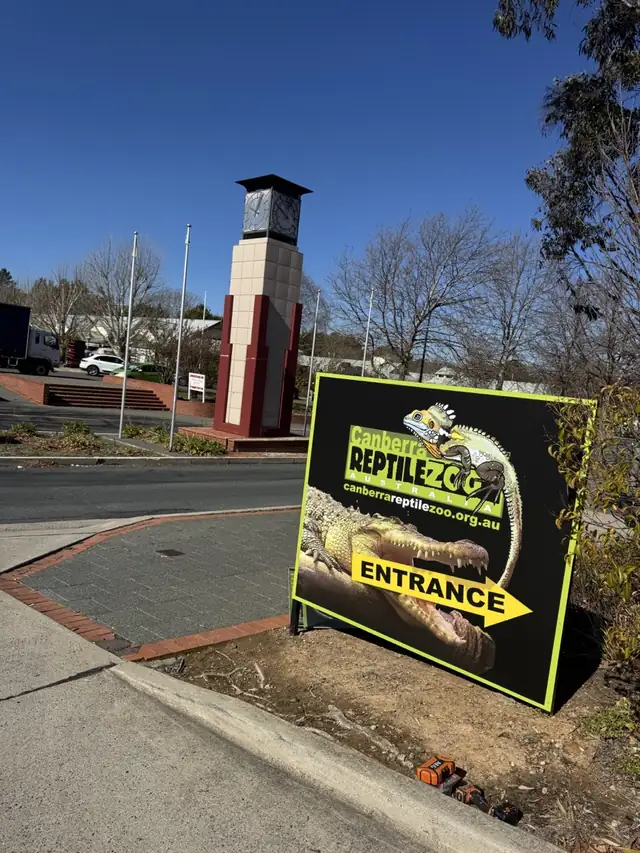The Canberra Reptile Zoo entrance sign beside the Gold Creek clock tower
